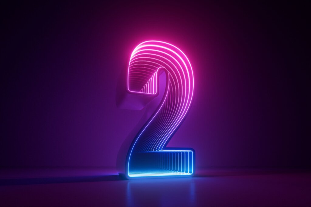 Veja como usar a numerologia para escolher o dia do seu casamento 40 Ilustração do número dois em rosa e azul em um fundo preto