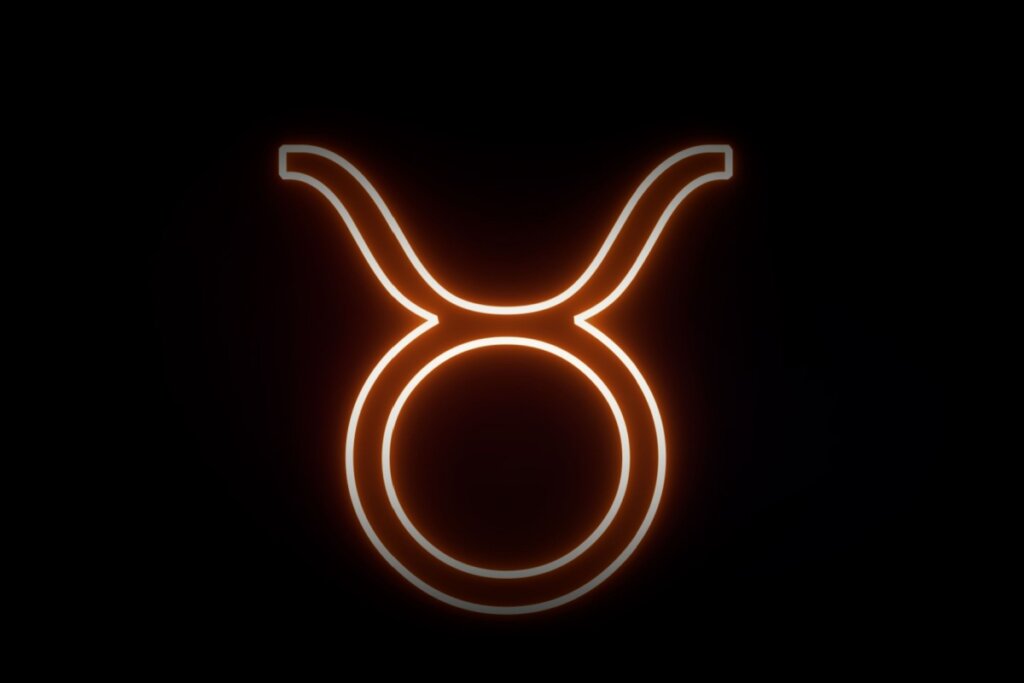 Ilustração digital do símbolo de Touro (um círculo encimado por dois chifres curvos). O design tem um aspecto de luz neon vibrante em tons alaranjados sobre um fundo preto.